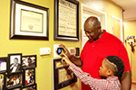 Allens family looking at a nest thermostat