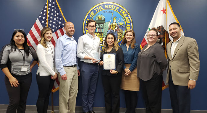 From left to right:  CalSavers team members Alyssa Delacruz, Carolina Hernandez, Brian Gould, November Employee-of-the-Month Eric Lawyer, State Treasurer Fiona Ma’s Chief of Staff, Genevieve Jopanda, CalSavers Executive Director Katie Selenski, Angela Duvane, Jonathan Herrera.