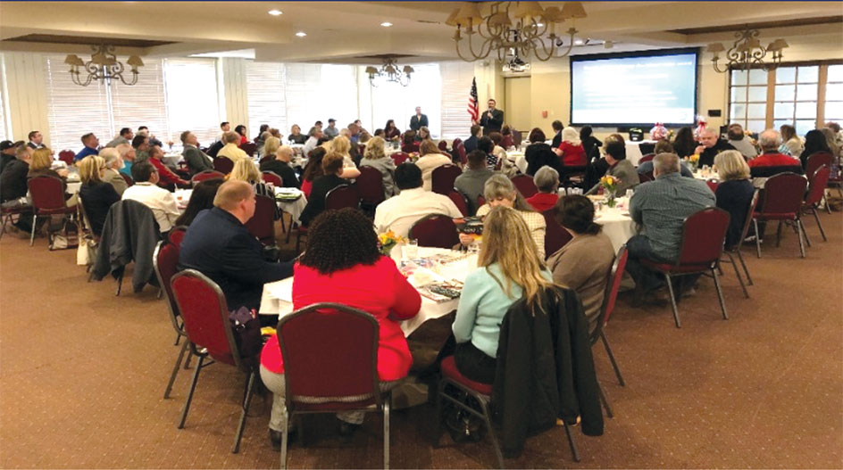 A DMV speaker explains REAL ID driver licenses and identification cards to Victorville area chamber of commerce members.