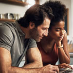 Couple looking at computer Couple looking at computer