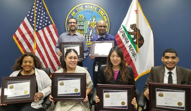 Treasurer Fiona Ma and staff proudly display contracting awards